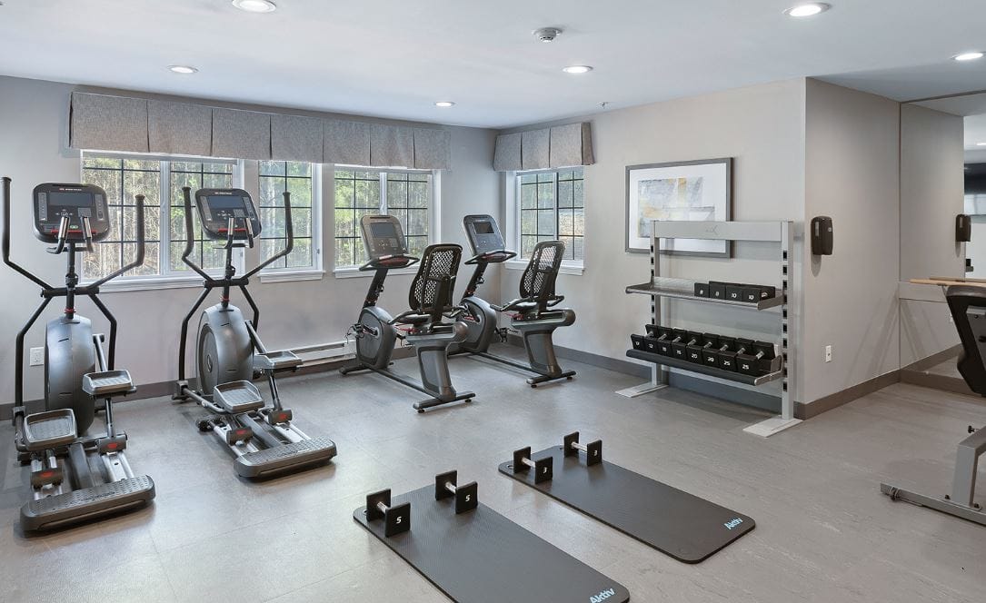 Modern gym with exercise equipment and weights at Solista Orem.