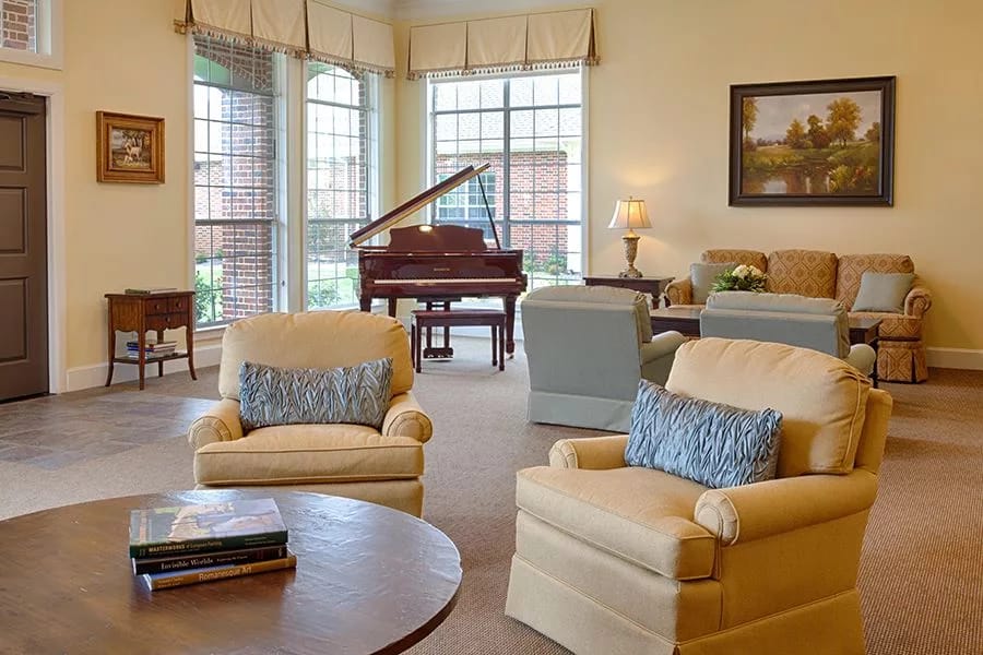 Inviting living room with a piano and comfortable seating.