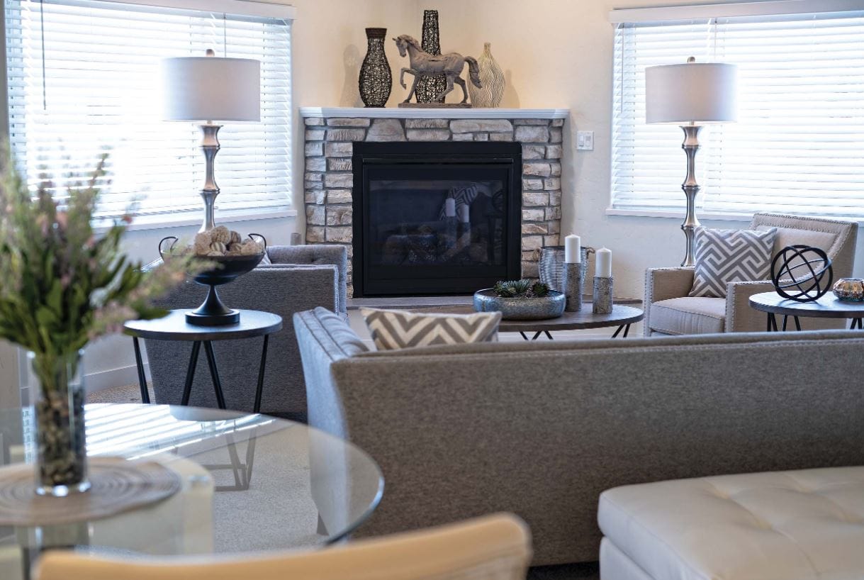Modern living room with a stone fireplace and comfortable seating