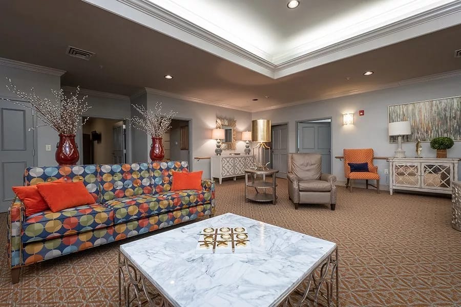 Colorful living room with patterned couch and marble coffee table