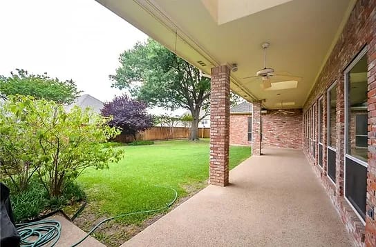 View of the patio with a garden area