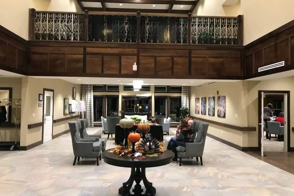 Cozy lobby with seating, seasonal decor, and a balcony