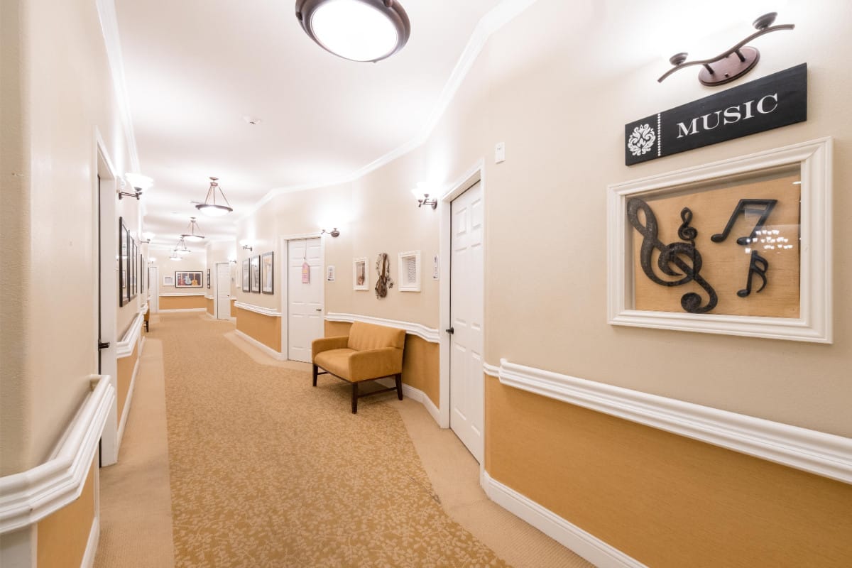 A hallway featuring music-themed decorations and a bench.