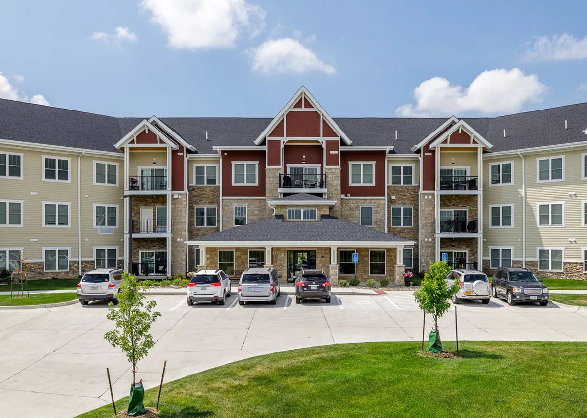 Front view of the Vintage Cooperative of Ames building with parked cars.