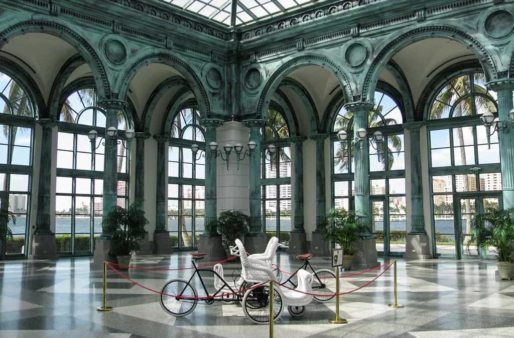 Bright and airy lobby featuring arches and a bicycle display.