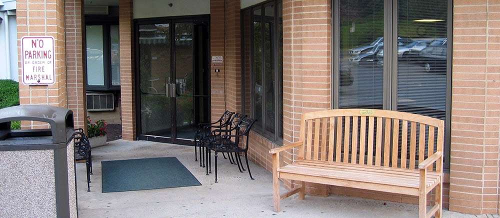 Entrance area featuring a bench and sign