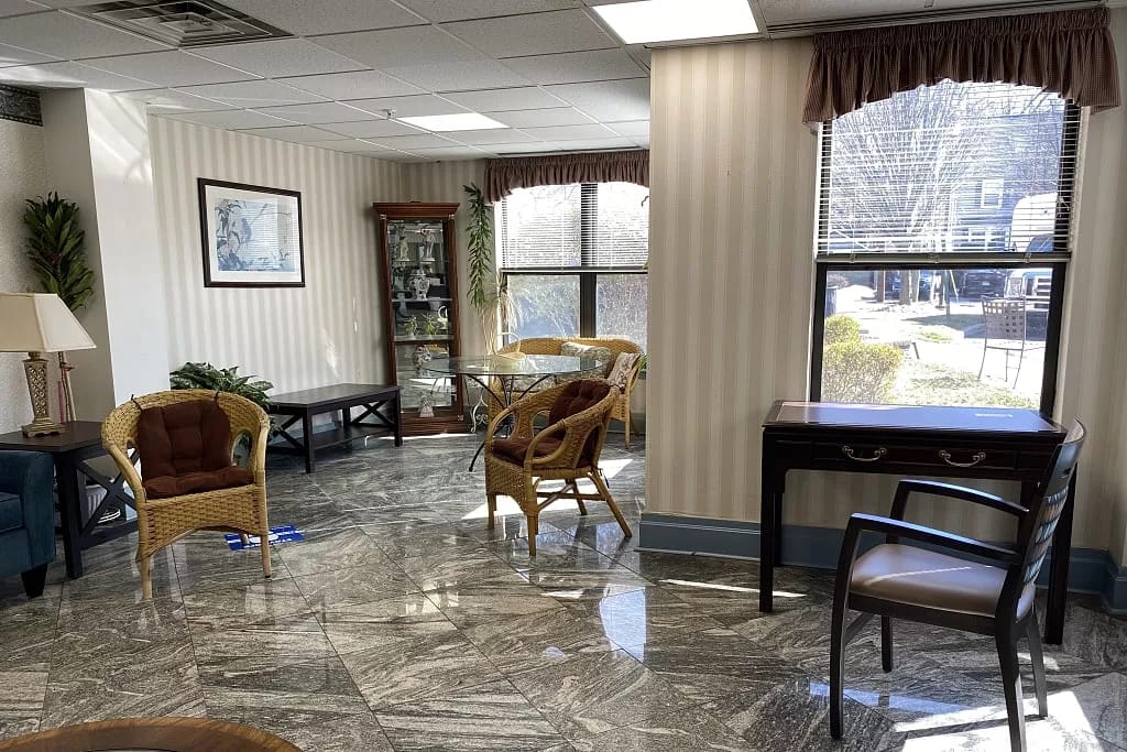 Lounge area with wicker chairs and a glass table