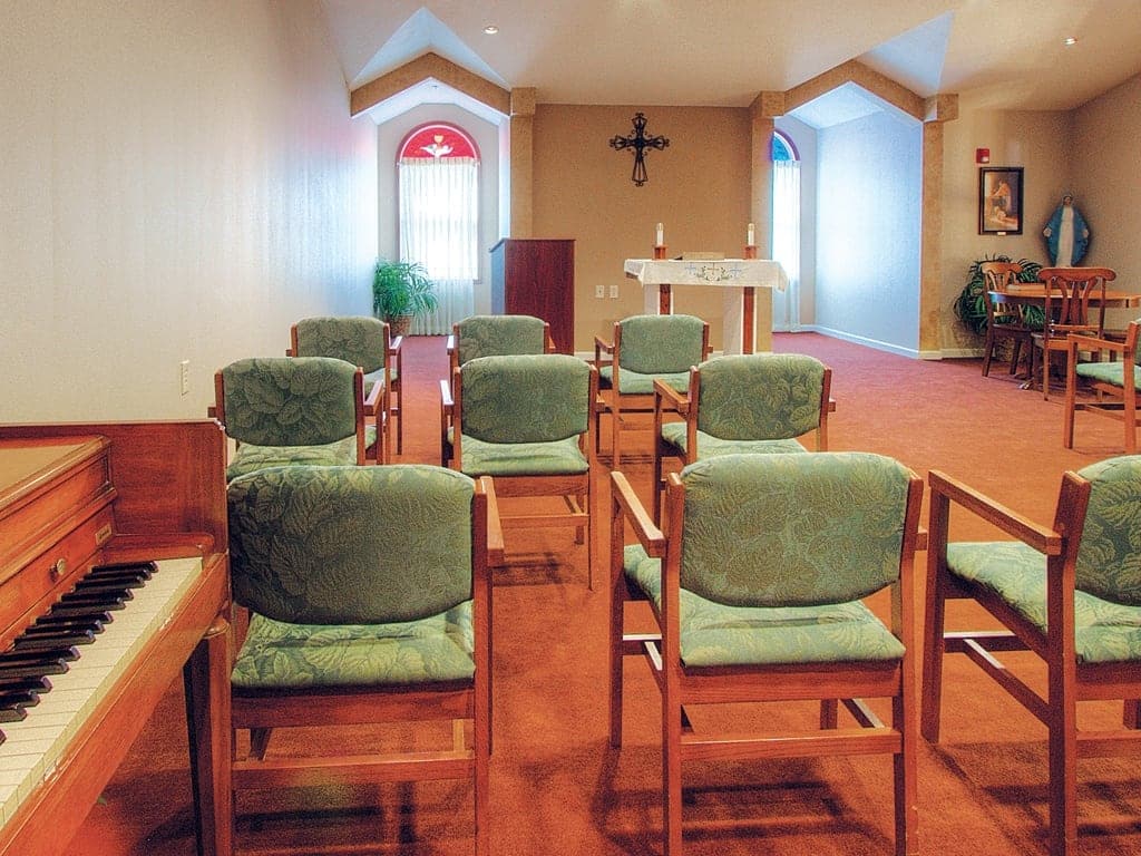 Chapel interior with chairs and altar at The Heritage at College View.