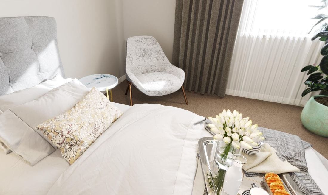 Comfortable bedroom with a bed, chair, and flowers