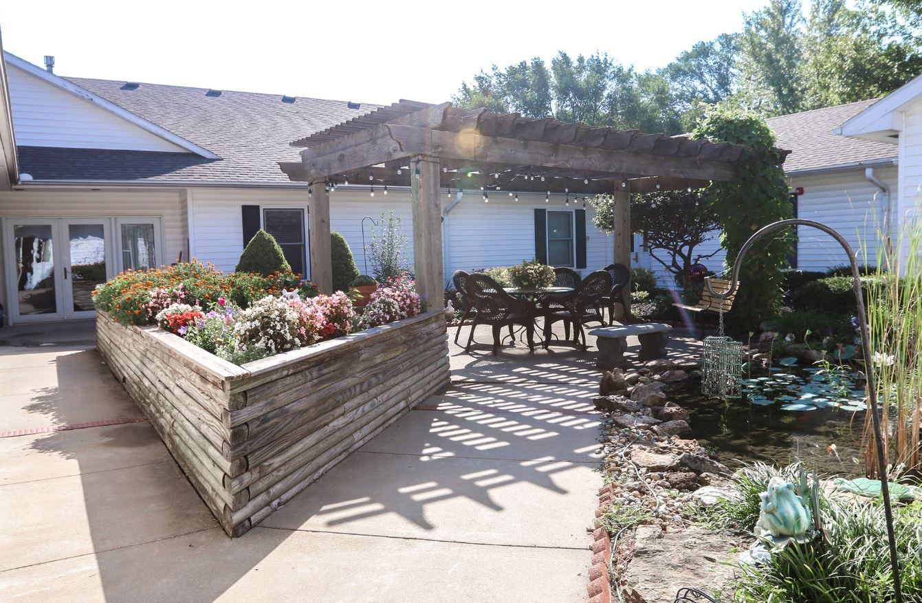 Outdoor patio area with flowers and seating at Vintage Park at Louisburg