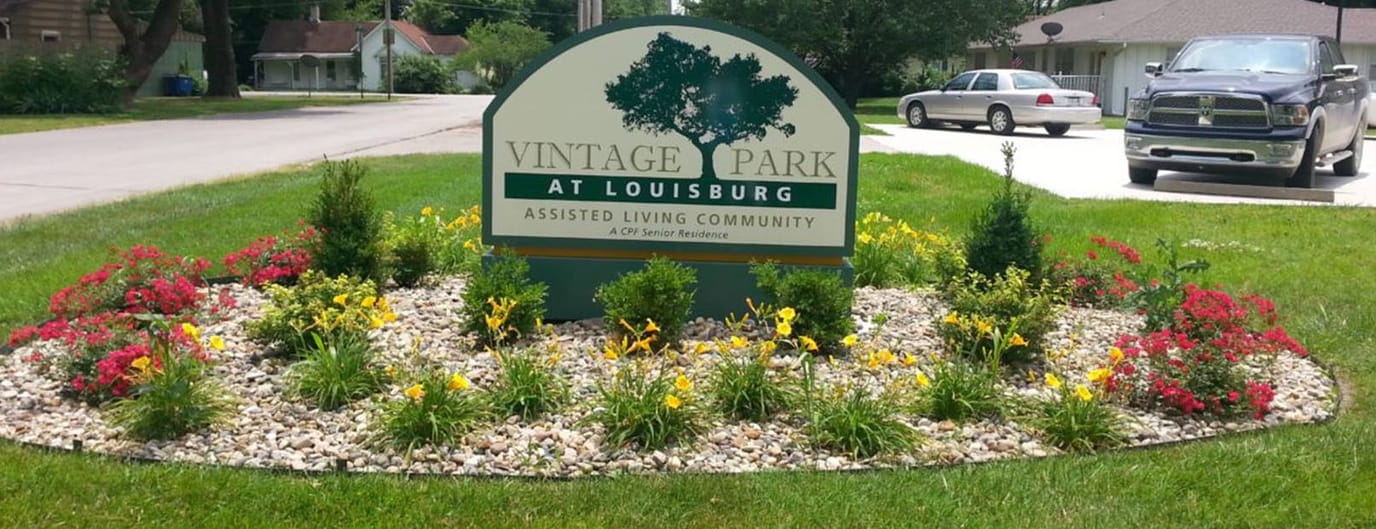 Sign for Vintage Park at Louisburg with flowerbed