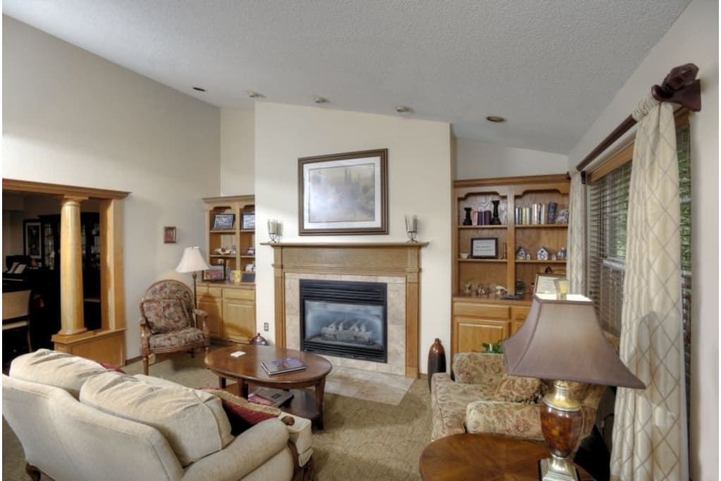 Inviting living room with a fireplace and bookshelves