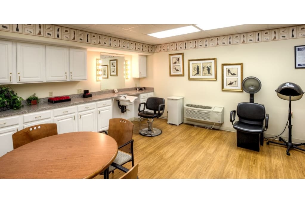 Interior view of the salon area with styling chairs and a round table.