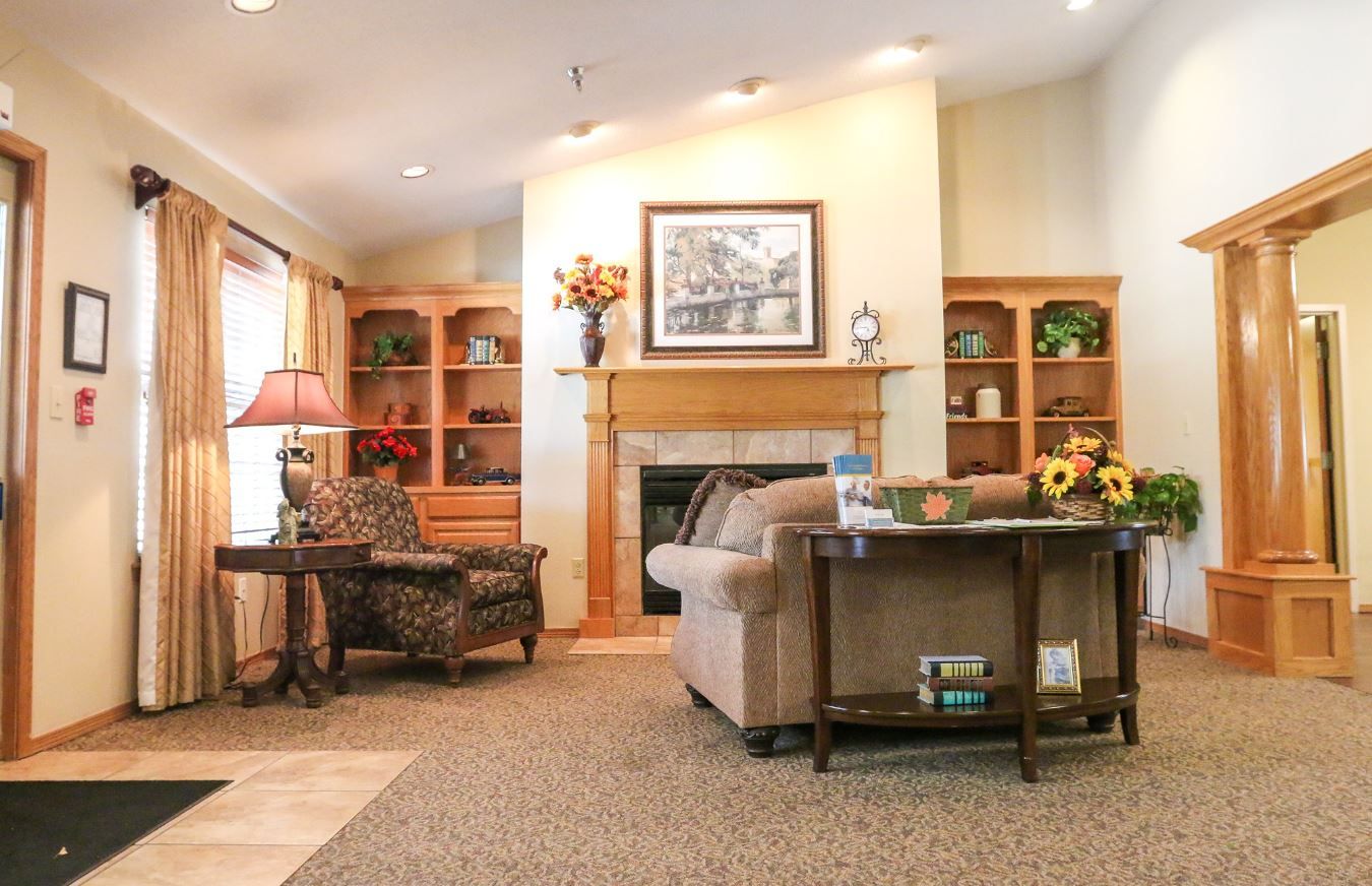 Living room with comfortable seating and decorative shelves.