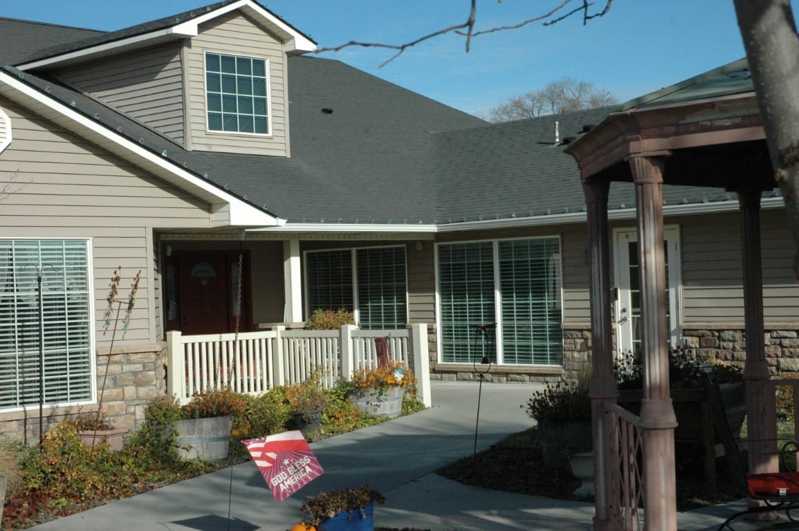 View of the entrance with a porch and landscaped front yard