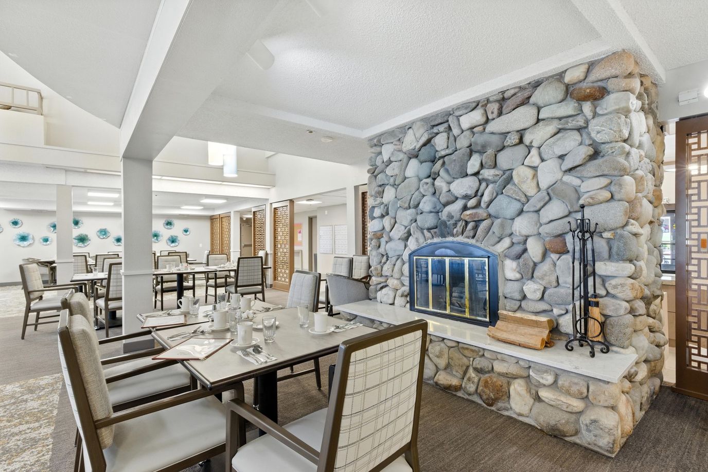 Interior dining area with stone fireplace and tables