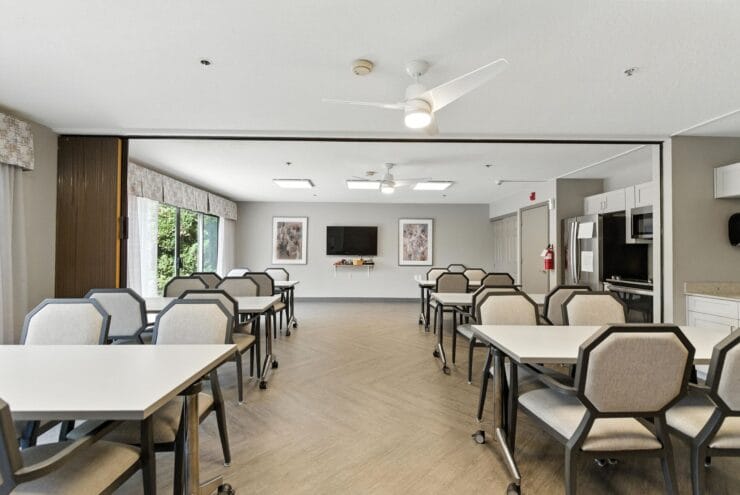 Spacious common area with tables and chairs