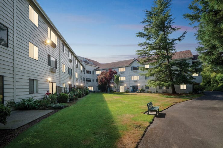 Exterior view of the assisted living facility with gardens