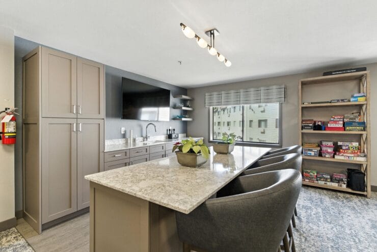 Modern kitchen area with seating and shelving