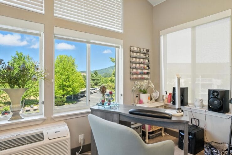 Bright salon room with windows and manicure supplies.