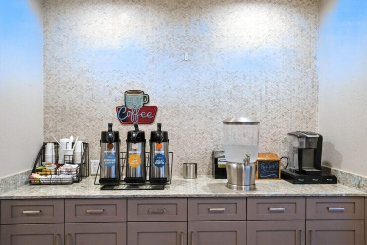 Coffee station with dispensers and snacks.