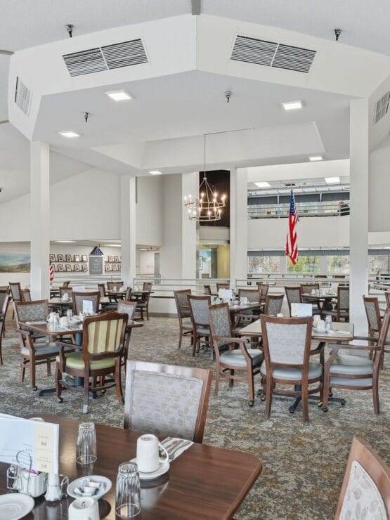 Dining area with tables and chairs, American flag visible