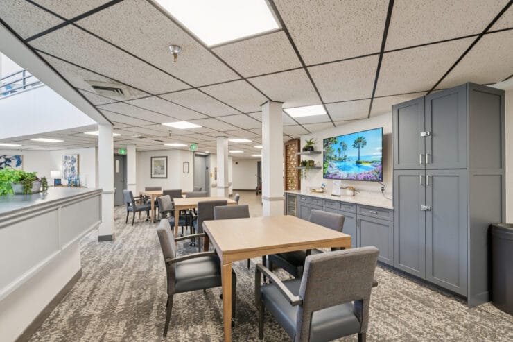 Bright common area with seating and TV.