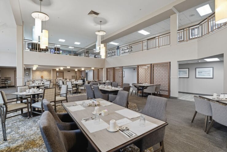 Spacious dining room with tables set for meals.