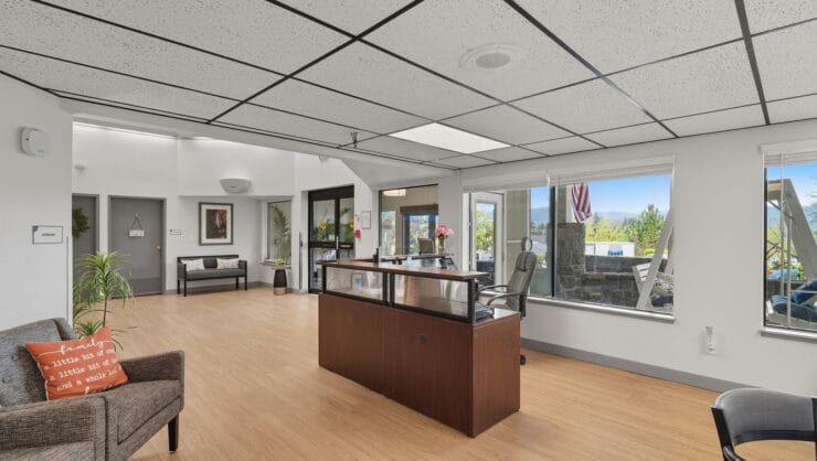 Bright reception area with sunlight and seating