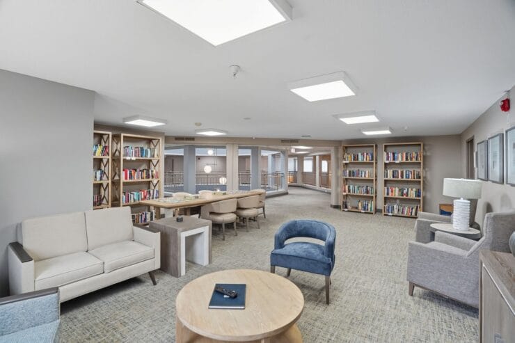Spacious common area with bookshelves and seating