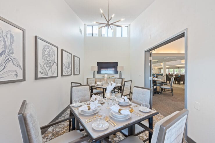 Elegant dining area with set tables and artwork.