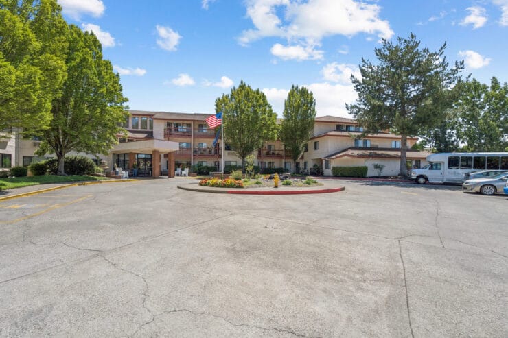 Exterior view of the assisted living facility with landscaping.