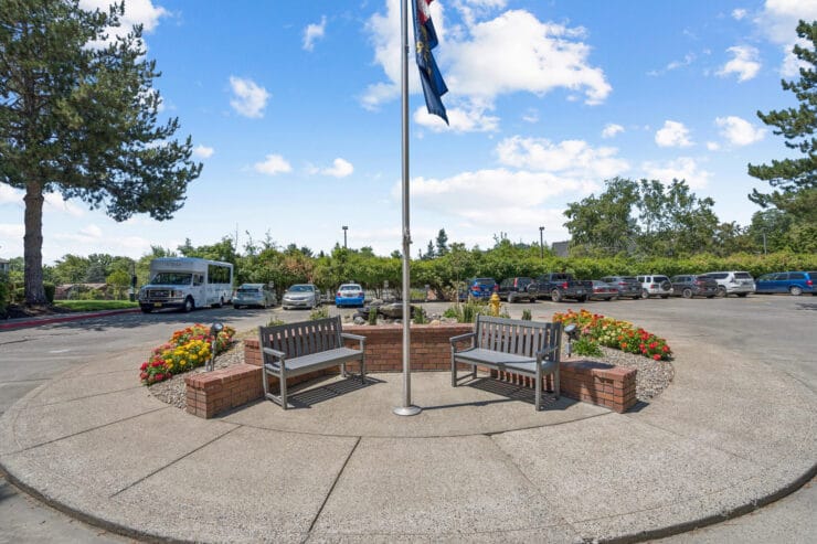 Outdoor seating area with benches and flowerbeds