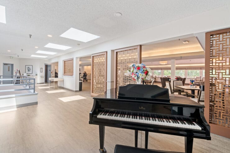 Piano in a welcoming common area with residents.