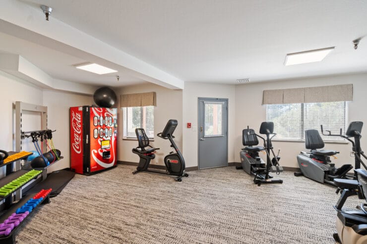 Fitness center with exercise equipment and vending machine.
