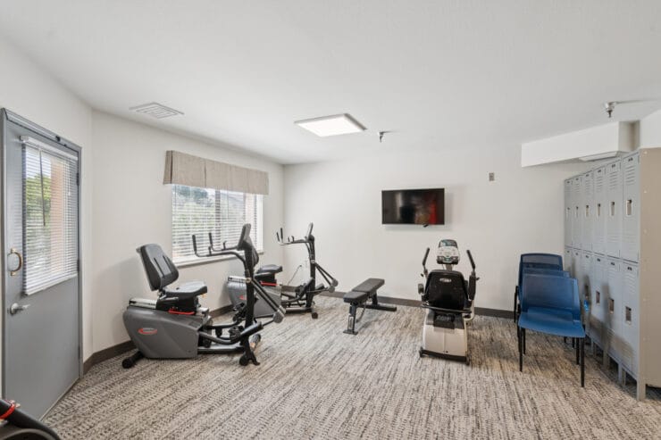 Fitness area with exercise equipment and lockers.