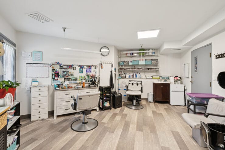 Interior view of a grooming area with salon chairs and equipment.