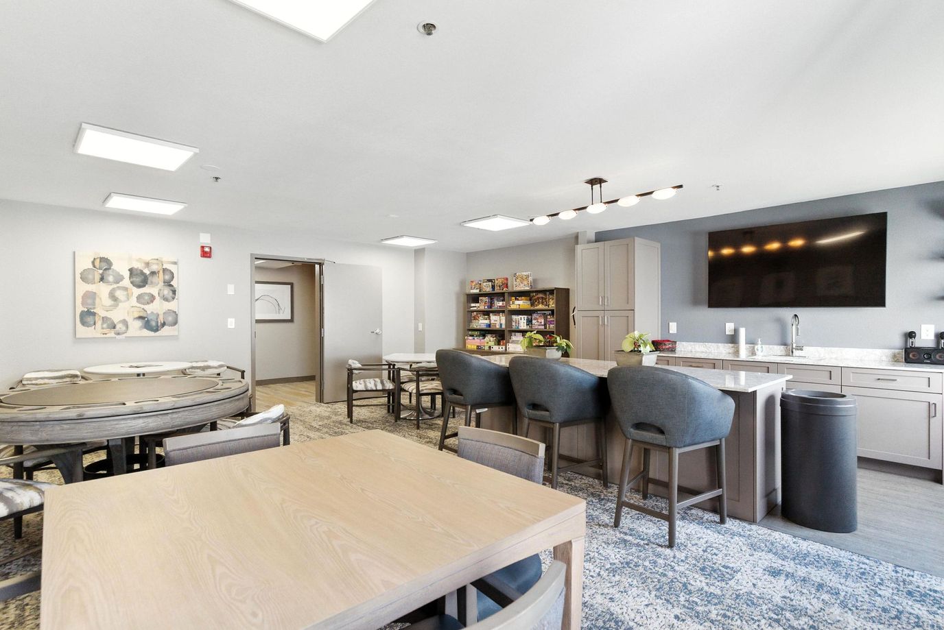 Common area with dining tables and kitchenette