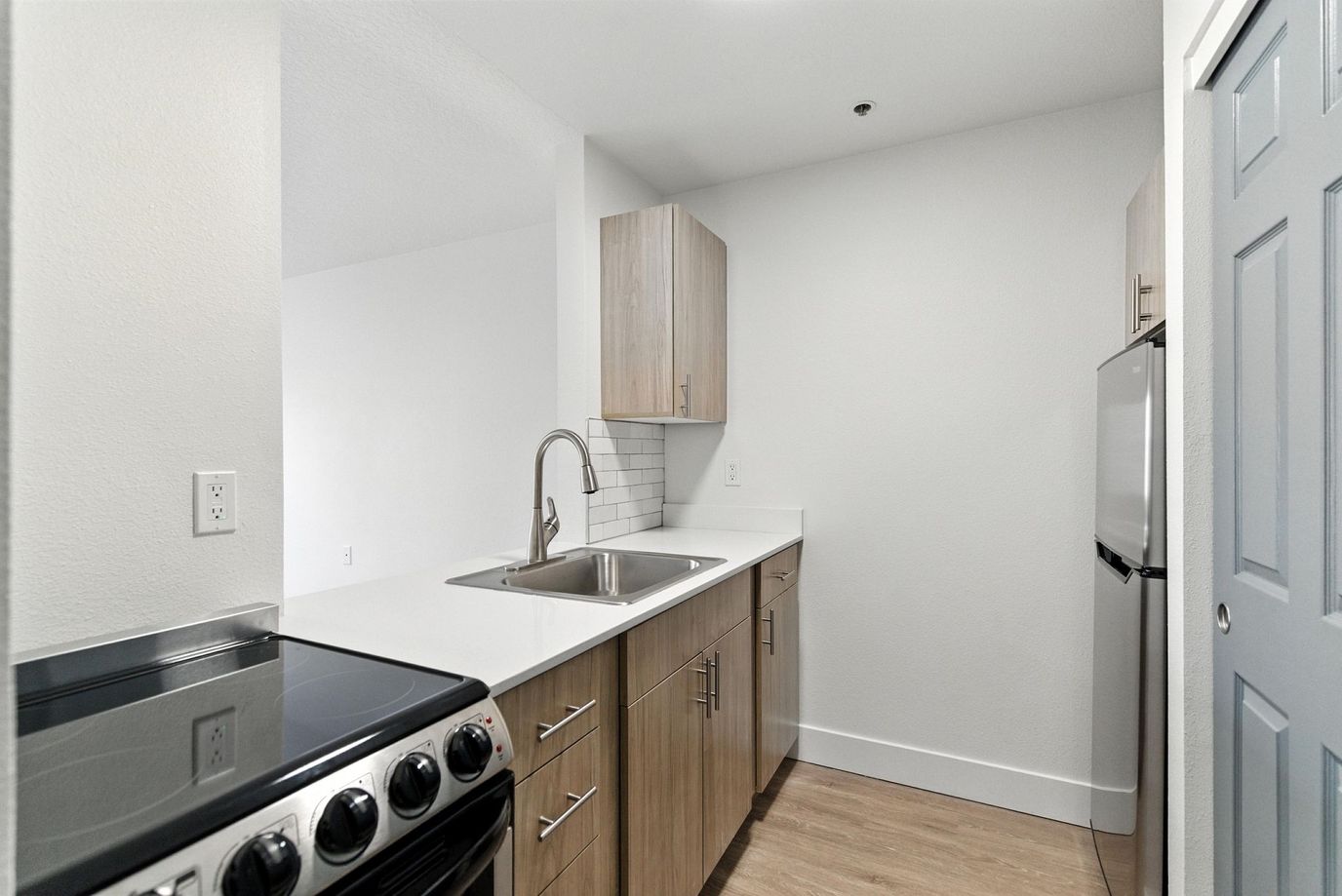 Contemporary kitchen featuring stainless steel appliances and wooden cabinetry