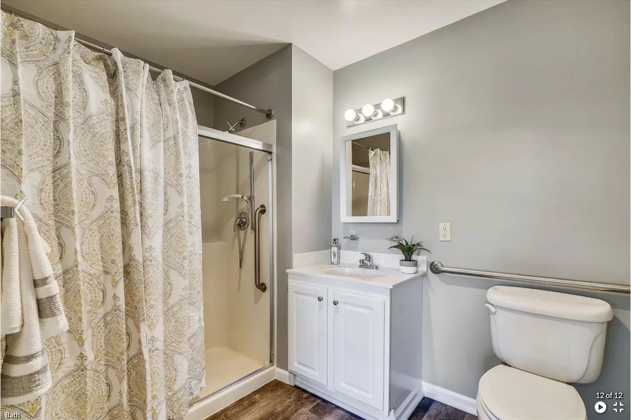 Modern bathroom with shower, vanity, and toilet.