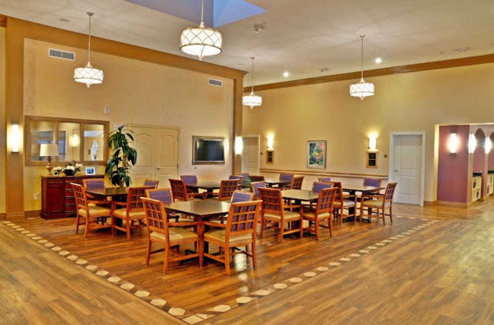 Brightly lit dining area with wooden tables and chairs