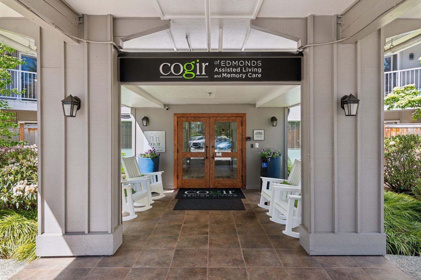 Entrance to Cogir of Edmonds with rocking chairs and signage