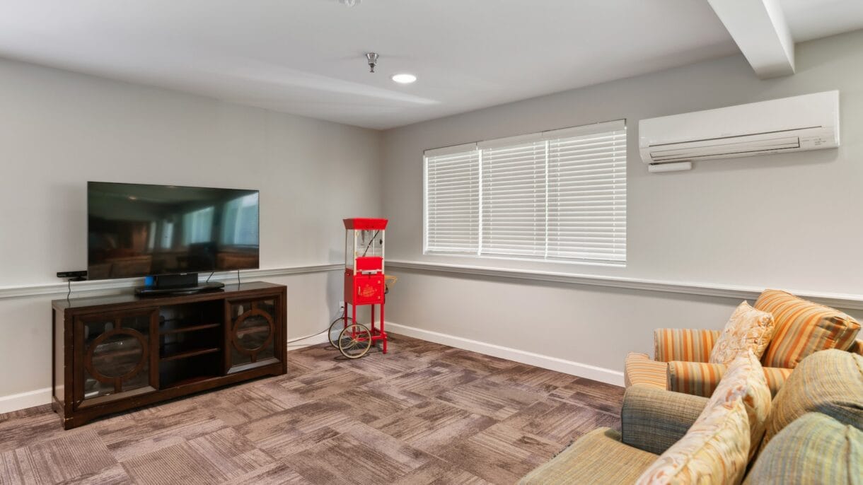 Bright common area with a TV and seating