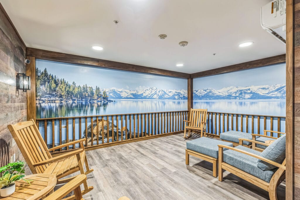 Cozy indoor seating area with a lake view mural