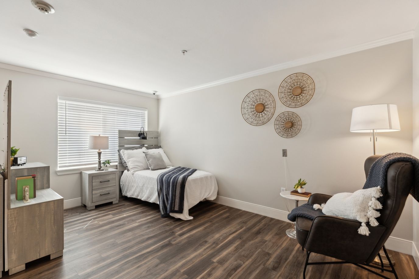 Bright, cozy private room with a bed and armchair
