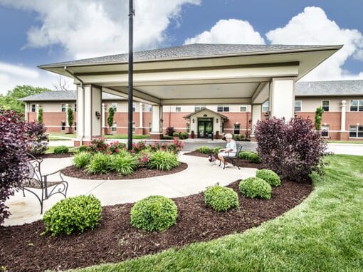 A welcoming entrance with seating and landscaping