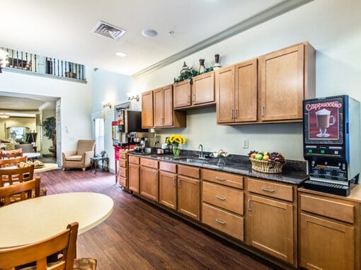 Interior kitchen area with cabinets and coffee machine