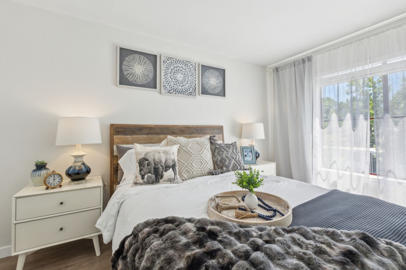 Well-decorated private resident room with bed and decor