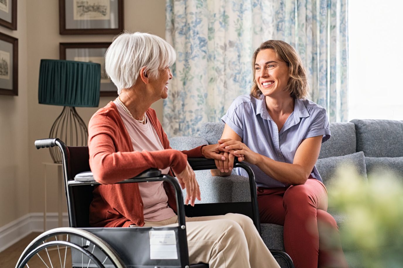 Resident and caregiver sharing a moment in a cozy lounge