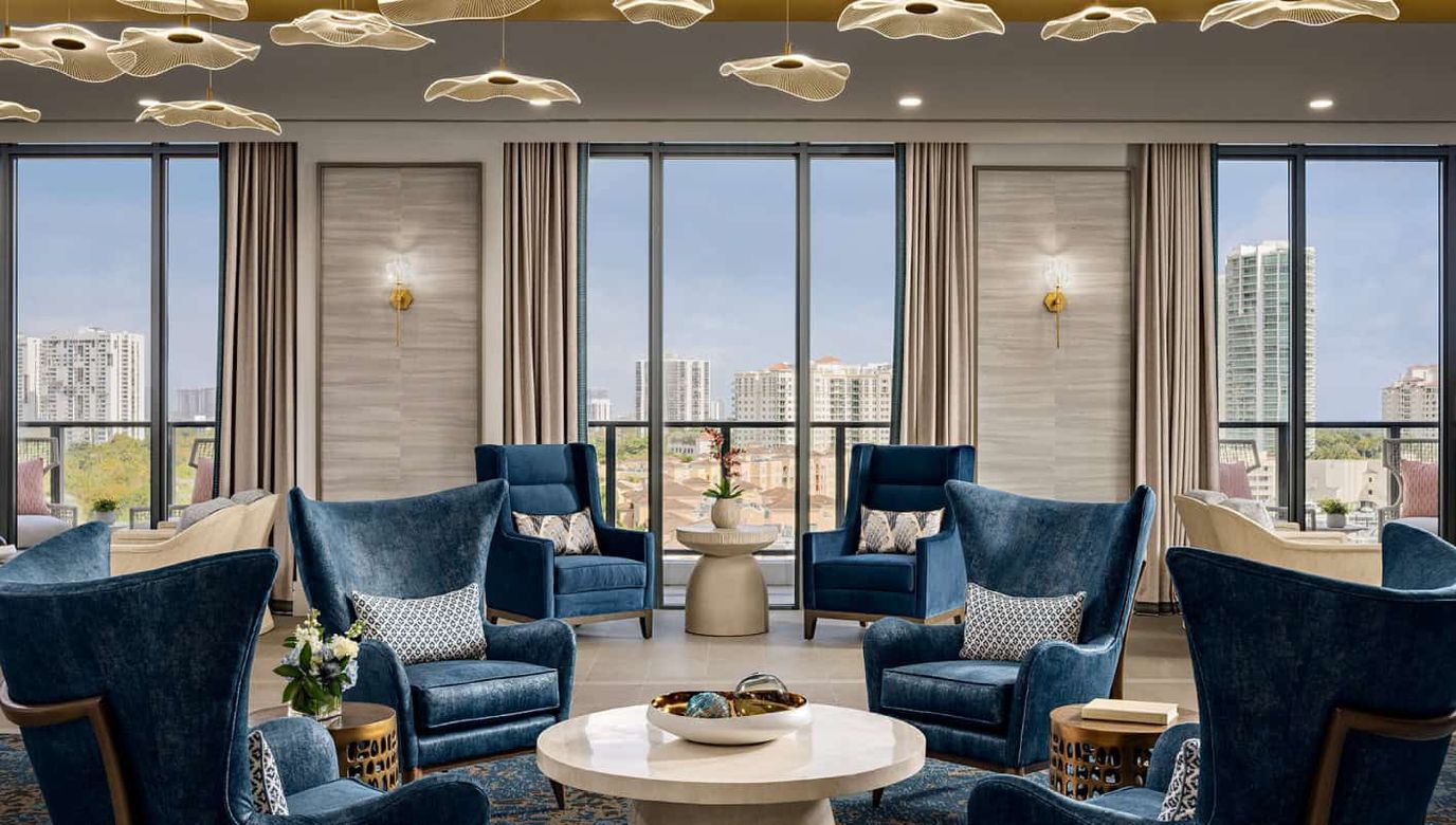 Bright common area with blue chairs and city view